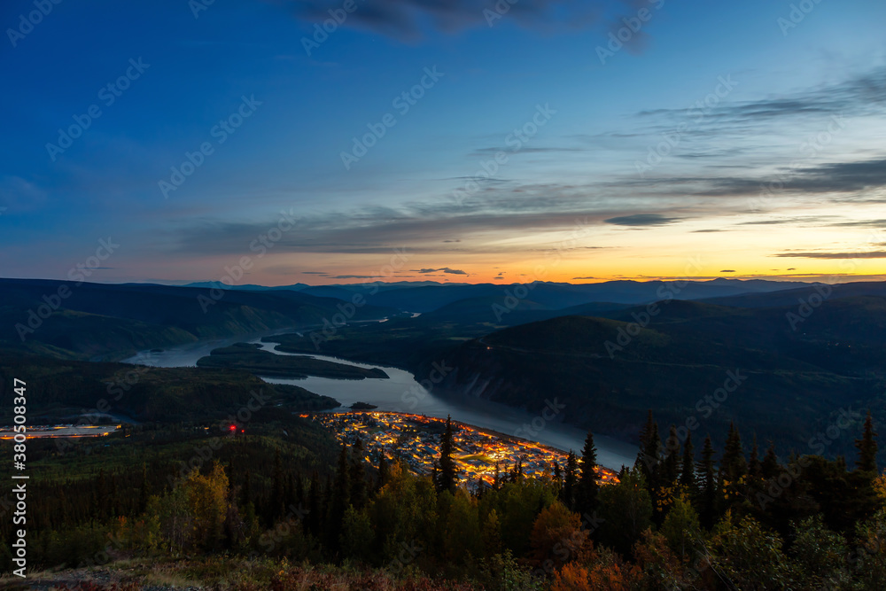 Panoramic View of Dawson City Lights from above at Night. Aerial Drone Shot. Taken from Midnight Dome Viewpoint, Yukon, Canada.