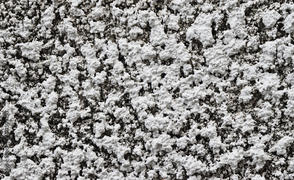 The rough and porous texture of the gray concrete wall, Black and white abstract background The rough and porous texture of the gray concrete wall, Black and white abstract background