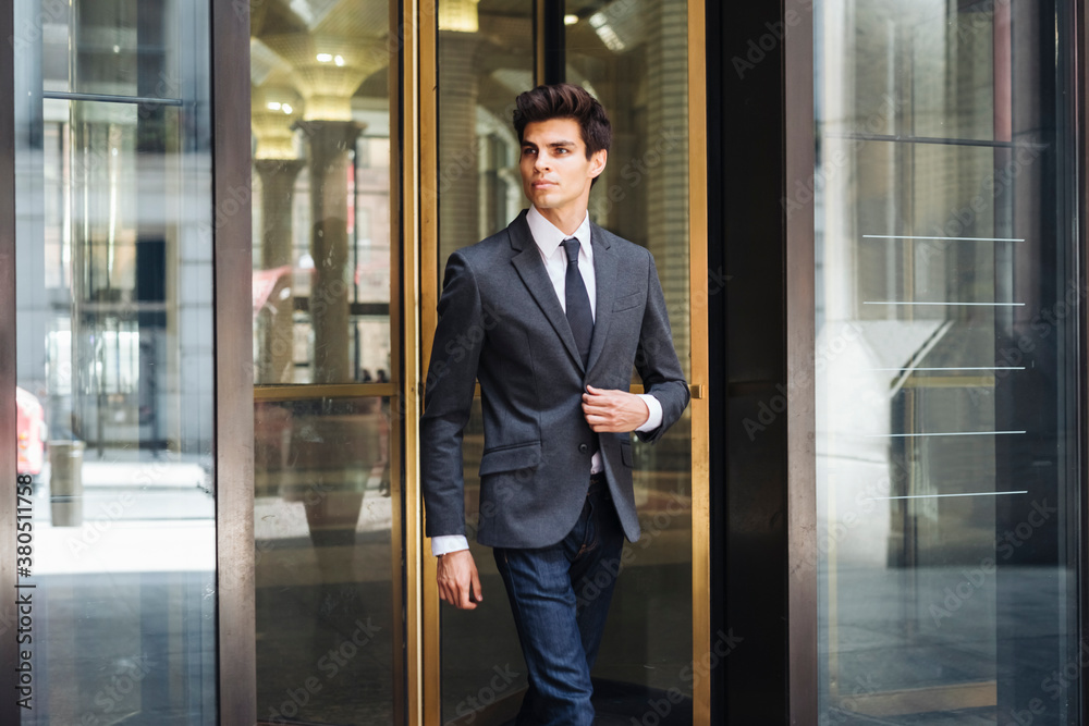 Elegant businessman going out the company
