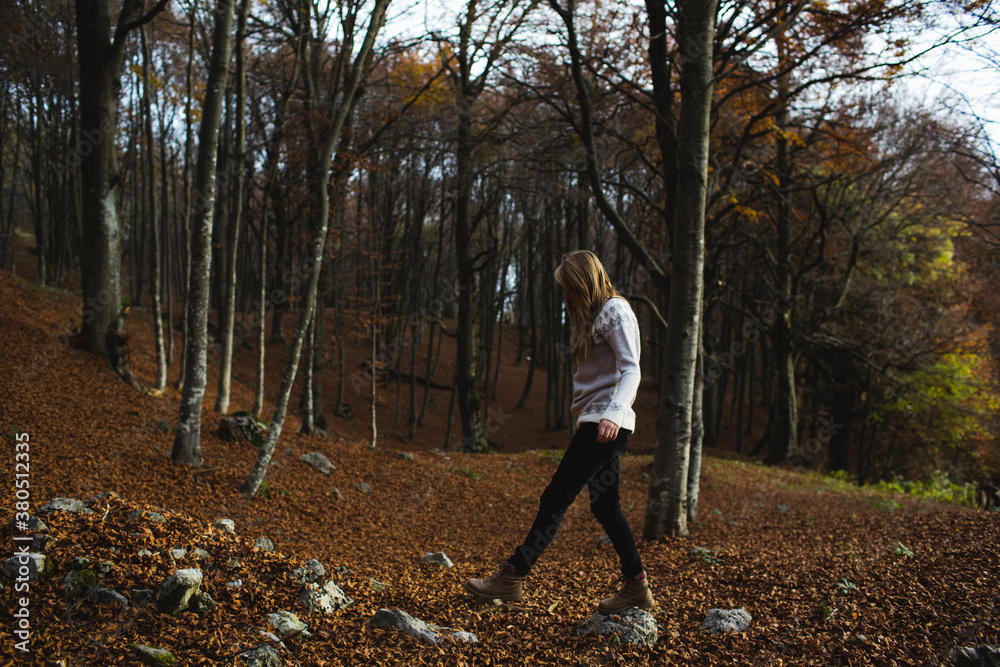 Young woman walking on the stones in the woods Young woman walking on the stones in the woods
