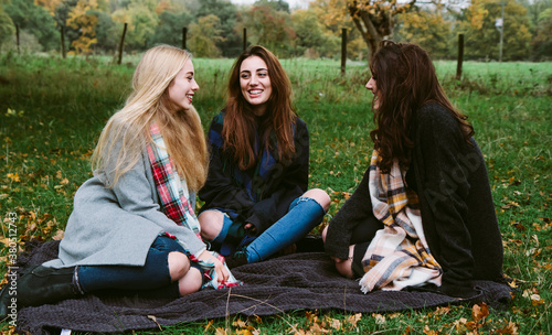 3 teenage girls hanging out together outdoors photo