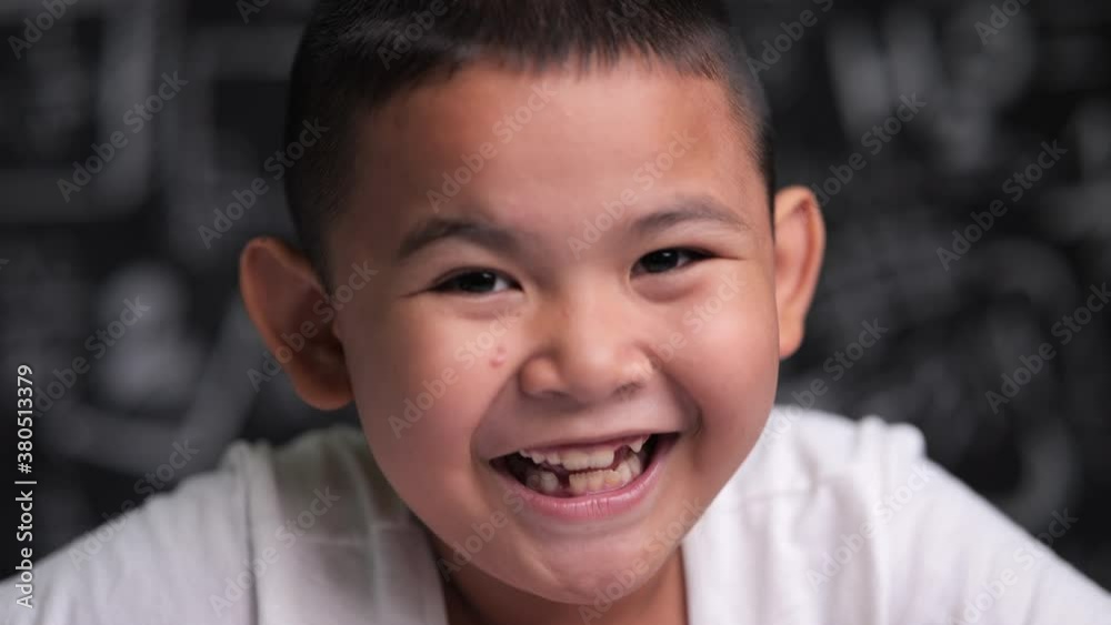 Close up portrait of Asian boy smiling and laugh Close up portrait of Asian boy smiling and laugh