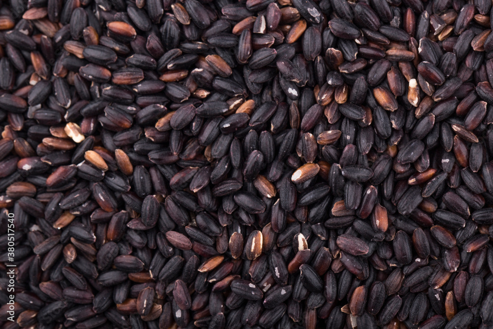 Close up background view of organic black purple rice. Close up background view of organic black purple rice.