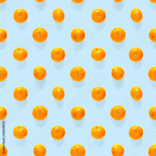 Fototapeta Naklejka Na Ścianę i Meble -  Fresh mandarine Seamles pattern. Ripe fruit tangerines seamless pattern. Fresh citrus isolated on blue background pattern. Flat lay of Clementine.