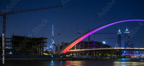 Part of "Tolerance bridge" structure in Dubai. "Dubai water canal", UAE. Tallest building in the world "Burj Khalifa" can also be seen on foreground. Outdoors