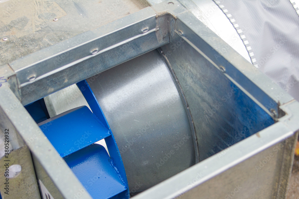 Obraz premium air ducts, a radial fan and a centrifugal engine prepared for installation, foreground and background blurred with bokeh effect