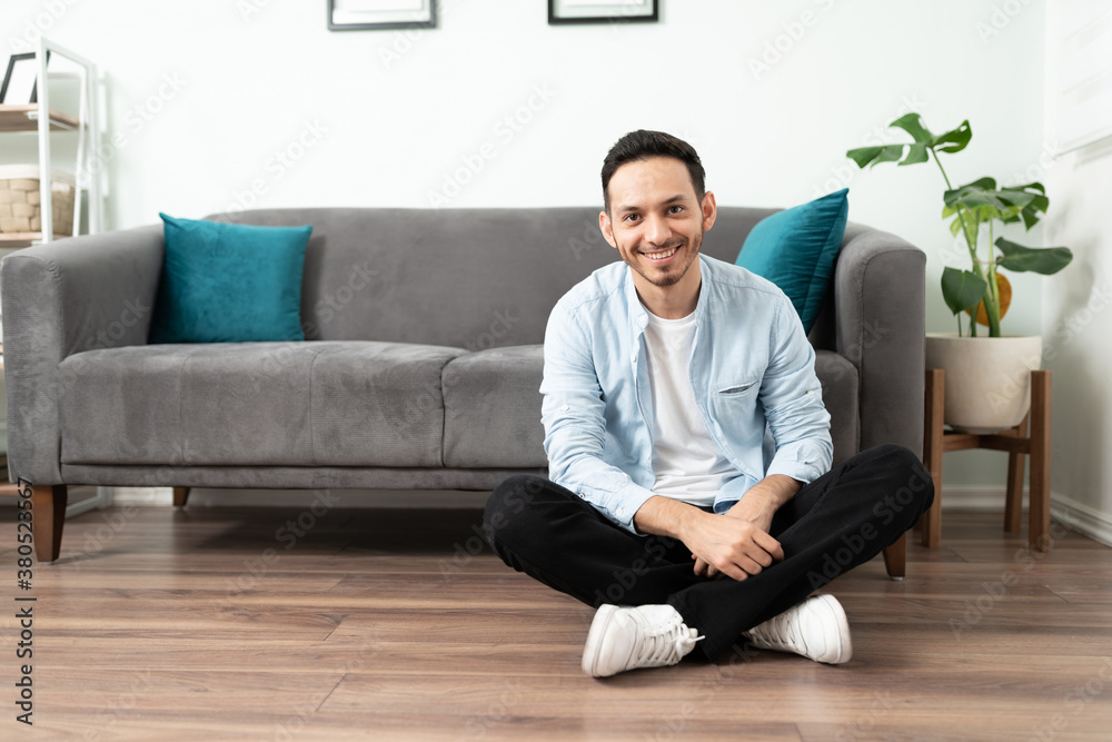 Attractive Hispanic man in his living room Attractive Hispanic man in his living room