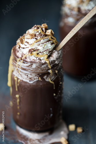 Hot chocolate with whipped cream and caramel sauce photo