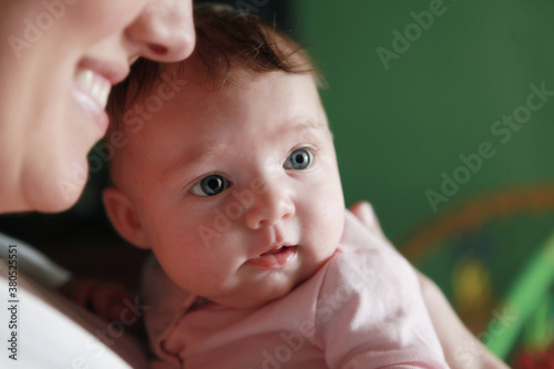 Smiling Mother Holding Beautiful Baby photo