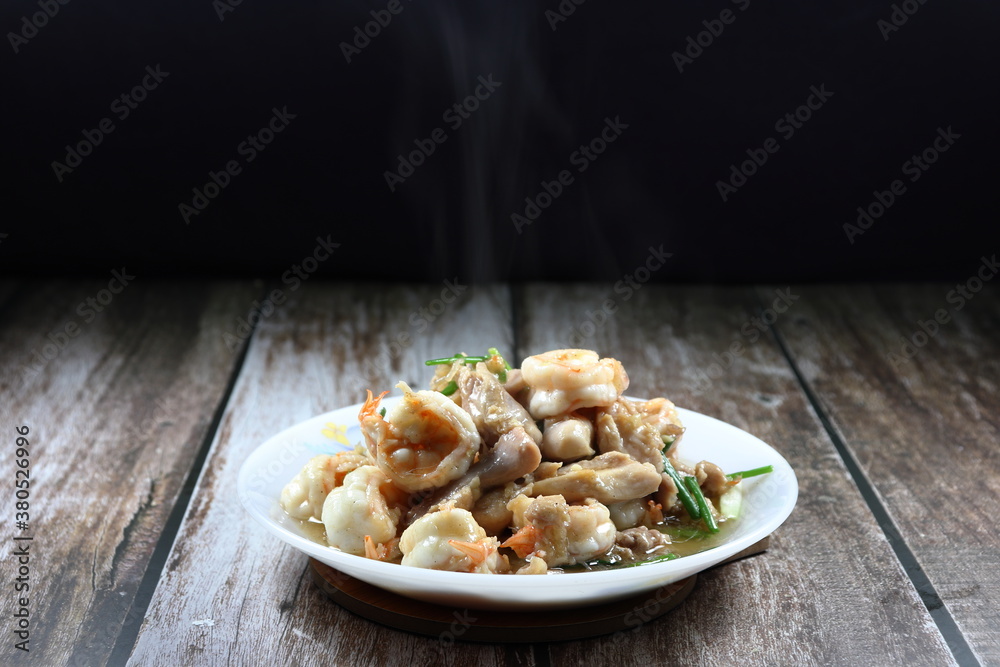 Fried and stirred fresh peeled shrimp, chopped chicken thigh, chilly and spring onion on the plate. Hot and spicy street food menu in Asia. Fried and stirred fresh peeled shrimp, chopped chicken thigh, chilly and spring onion on the plate. Hot and spicy street food menu in Asia.