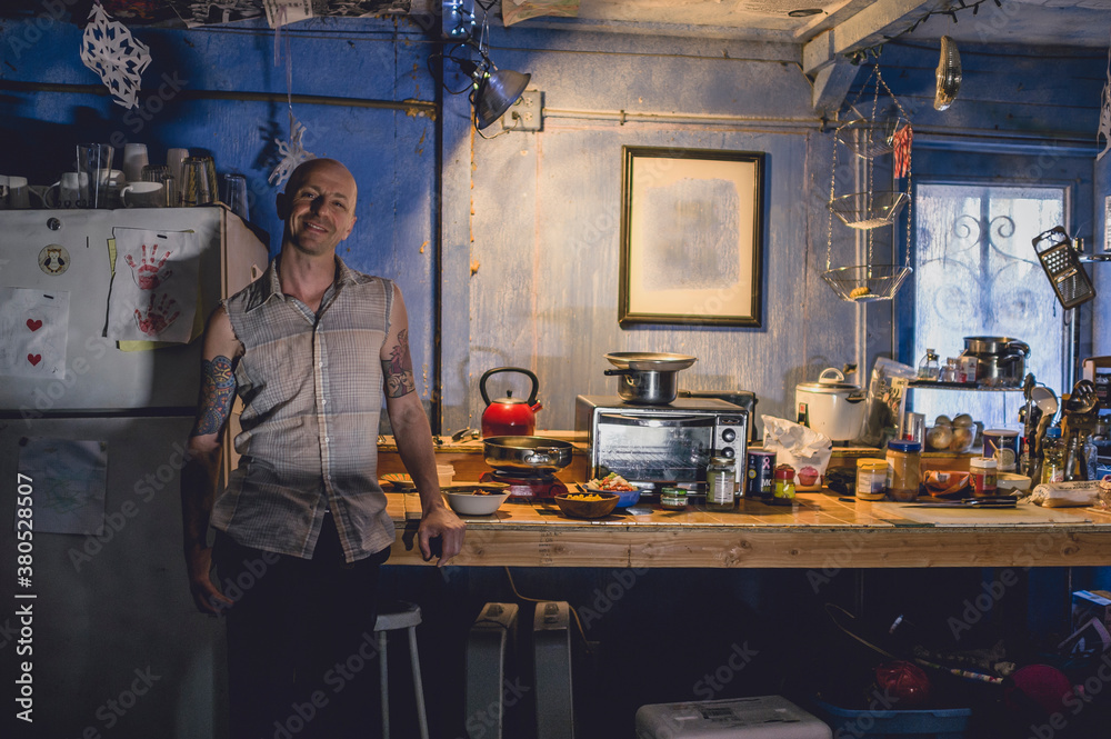 A tattooed artist in his ramshackle home. A tattooed artist in his ramshackle home.
