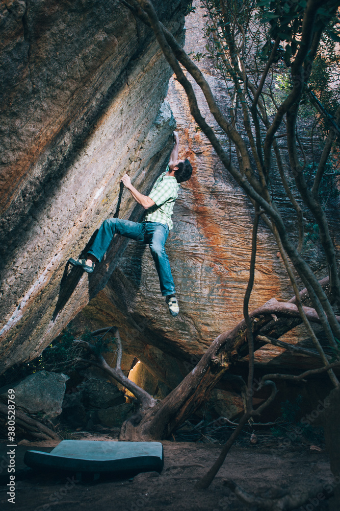Climber bouldering on a boulder outdoors