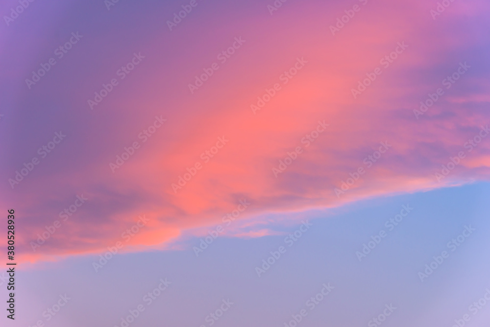 A soft and warm cloud sky with pink, orange purple, and blue hues