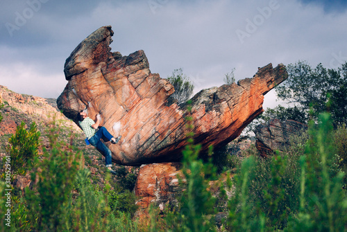 Climber bouldering on a boulder outdoors