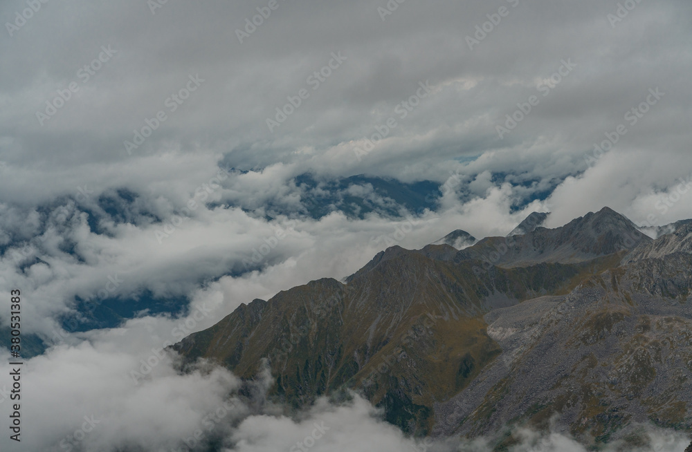 The mountain landscape with clouds around in Dagu glacier park in Sichuan, China.