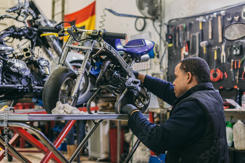 Mechanical Operator in a Motorbike Workshop photo