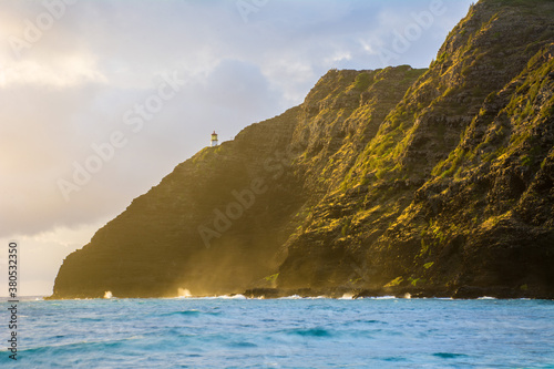 Lighthouse on cliff at Makapuu sunrise / sunset on Oahu, Hawaii photo