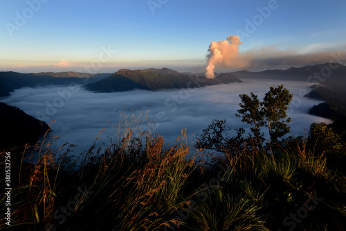 View of the top of Mount Bromo. fog shrouds around Mount Bromo. watching the sunrise of Mount Bromo from Argosari Peak, Lumajang, Indonesia photo