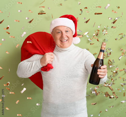 Elderly man with champagne ...