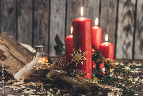 rural decorated advent wreath with four red burning candles photo