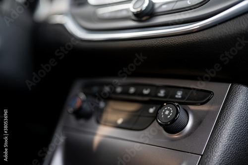 Modern car interior: steering wheel, gearshift lever, multimedia system. The air conditioning button inside a car. Car interior © alexanderuhrin