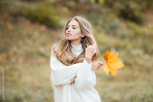 Fashion sensual woman walking in autumn park.
