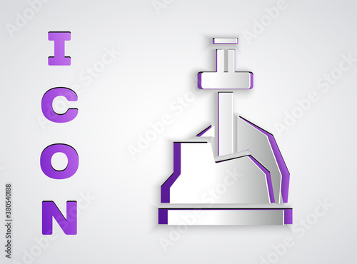 Paper cut Sword in the stone icon isolated on grey background. Excalibur the sword in the stone from the Arthurian legends. Paper art style. Vector.