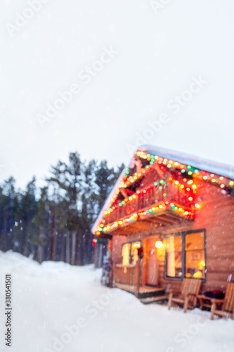 Wallpaper Mural Festive ski cabin decorated with holiday lights in a snowy setting Torontodigital.ca