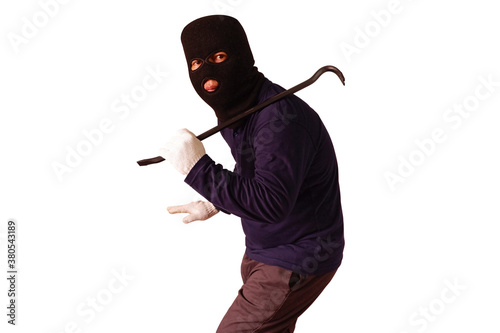 Masked thief holds steel crowbar in preparation for a pry, turned to look with a doubtful expression Isolated on white background