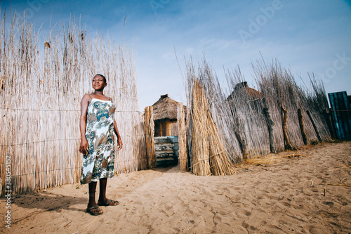 Proud young African Hambukushu woman outside her kraal photo