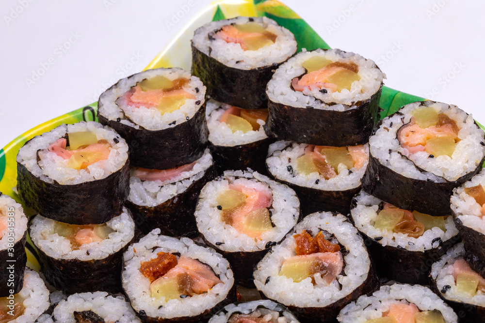 Top view of stack of Japanese sushi maki roll plate. Served in Japanese bar restaurant with chopstick Top view of stack of Japanese sushi maki roll plate. Served in Japanese bar restaurant with chopstick