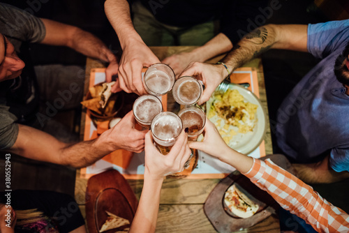 Friends cheering up in the restaurant photo