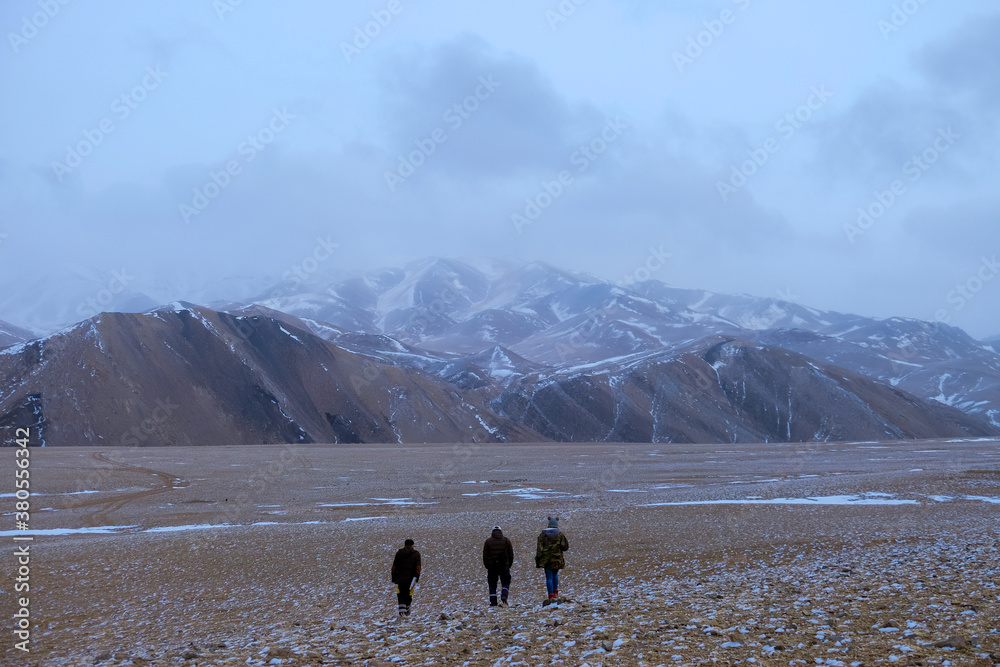 Friends are walking on the slop in Altai mountain area, Govi-Altai province, Mongolia.
