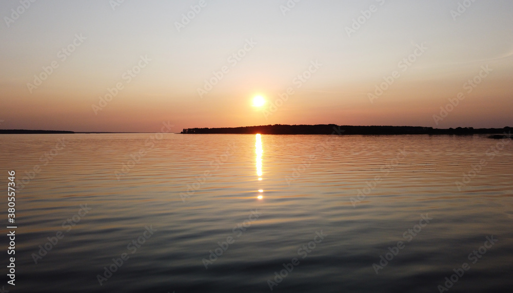 Beautiful sunset over a calm lake with reflection in the water