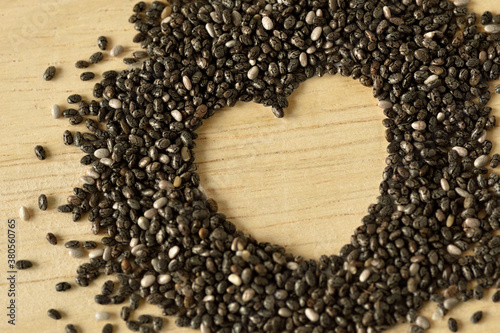 Chia seeds in the shape of heart on wooden background - Chia seeds are good for heart healthy © calypso77