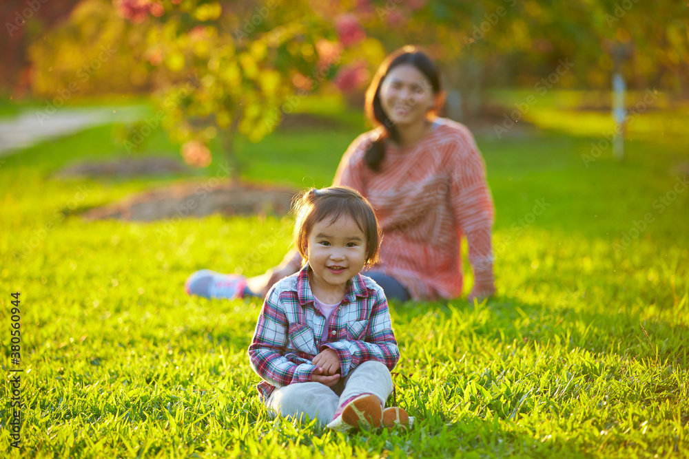 happy little girl with her mother outdoor in the sunshine park happy little girl with her mother outdoor in the sunshine park