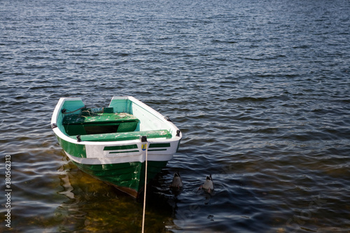empty rowing boat on the water on a summer day © Joanna Redesiuk