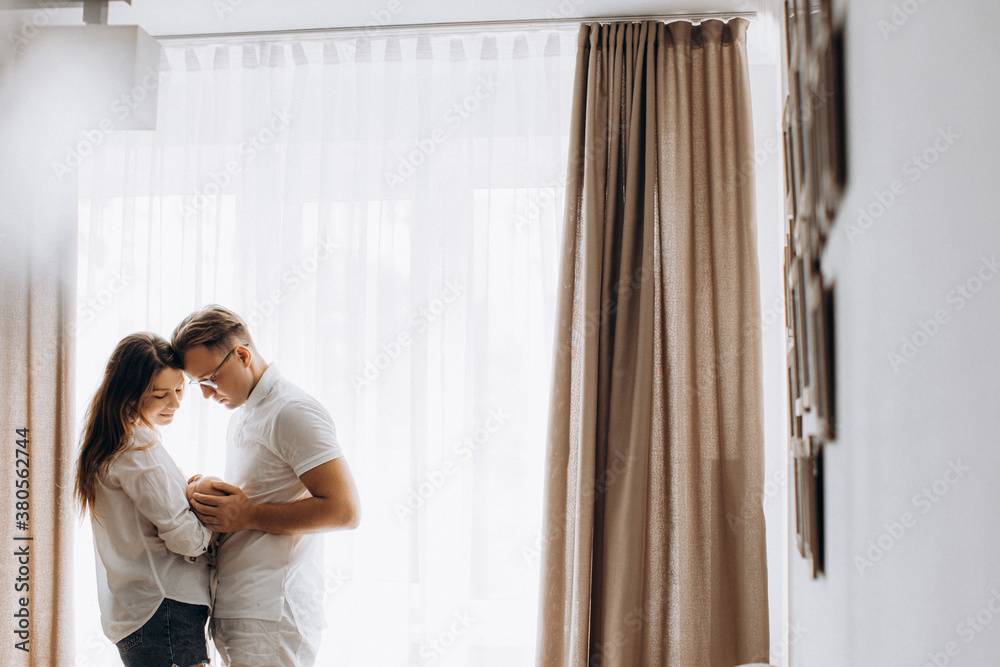 Lovely young parents with newborn baby at home, loving mother and caring father gently hold little daughter in arms, enjoy tender moments, happy family concept Lovely young parents with newborn baby at home, loving mother and caring father gently hold little daughter in arms, enjoy tender moments, happy family concept