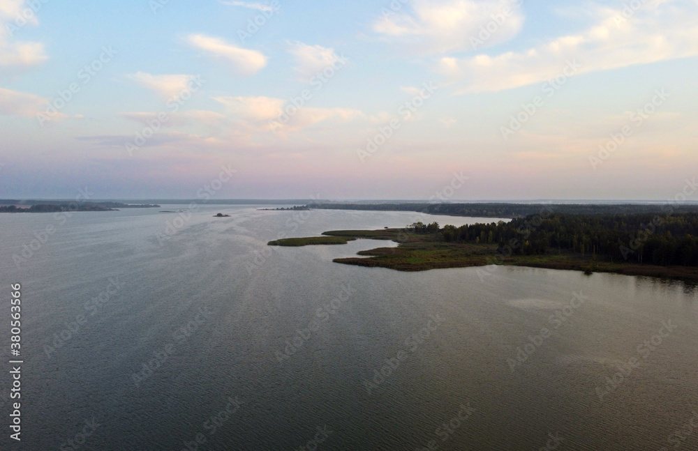 Top view at sunrise on a calm lake and forest Top view at sunrise on a calm lake and forest