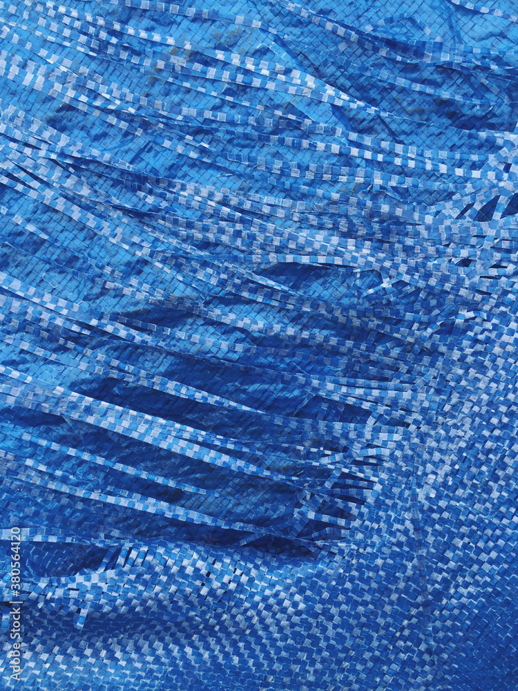 Close up of worn blue tarp Close up of worn blue tarp