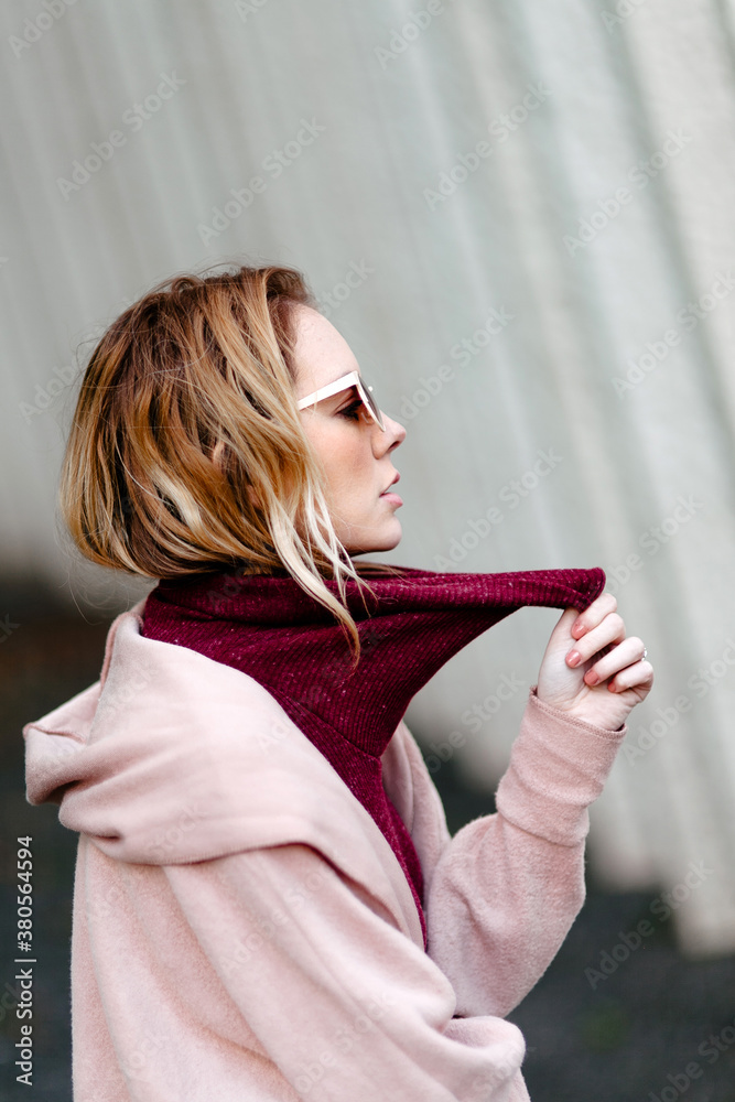 Pulling Neck Woman pulling her turtleneck away from her neck Stock Photo | Adobe Stock