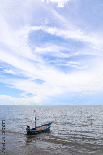 Fishing boat in the cloundy ocean