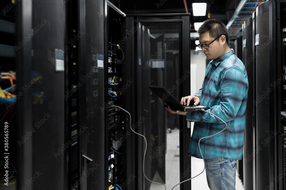 Young engineer working in datacenter Young engineer working in datacenter