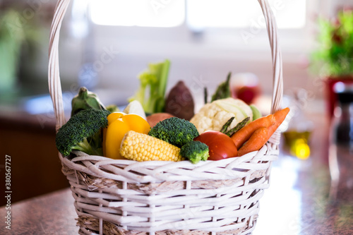 White basket full of different kind of fresh vegetables. Healthy eating concept and detox diet. Vegan and vegetarian food.