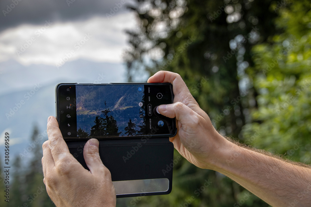 taking a photo during vacation in the mountains with your smartphone