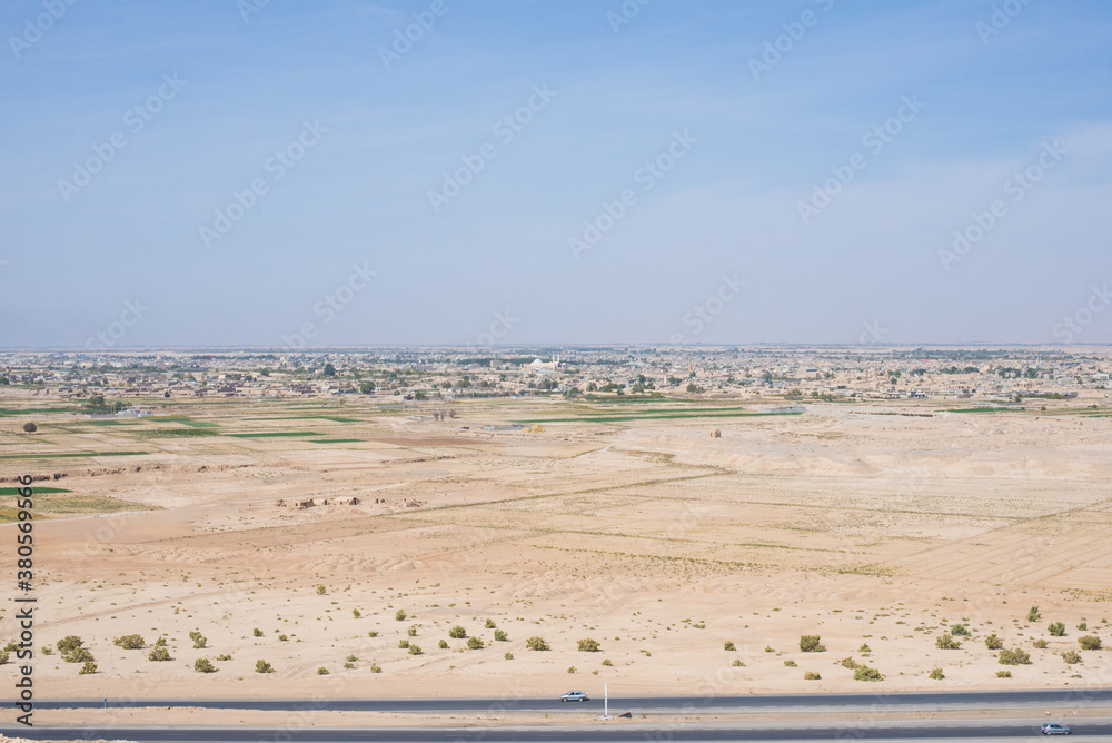 Landscape with straight tarmac road in the foreground Landscape with straight tarmac road in the foreground