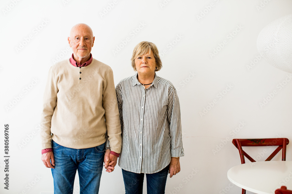 Portrait of an elderly couple standing on white. Portrait of an elderly couple standing on white.