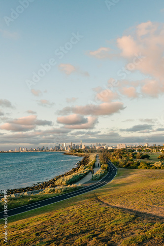 city skyline with a park and bay in the foreground, with some people taking a late afternoon stroll photo