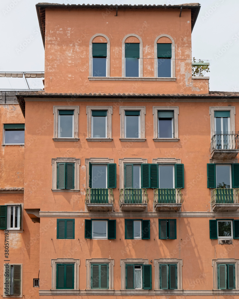 orange walls house front with green windows, Rome Italy