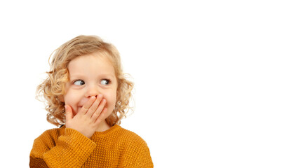 Shy funny child covering his mouth
